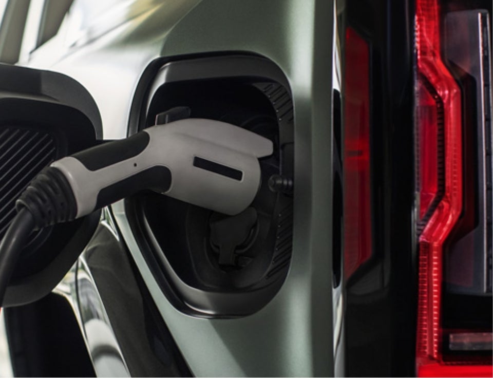 Close up of charging port with charger plugged in on a GMC Hummer EV SUV - GMC of Bedford Hills in BEDFORD HILLS NY