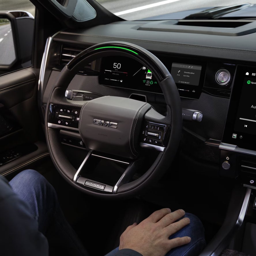 The steering wheel and dashboard of a new 2027 GMC Sierra 1500 truck